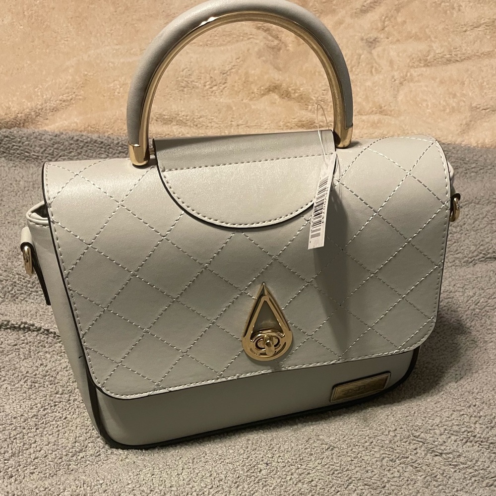 Gray top handle purse. Spacious and can hold the biggest iPhone you have.